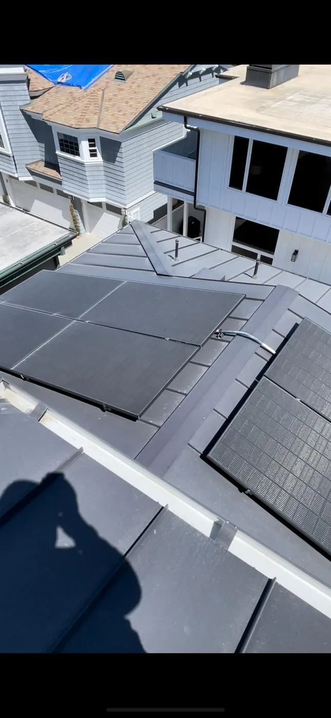 Solar panels mounted on a standing seam metal roof using clamp-on rail mounts, no roof penetrations